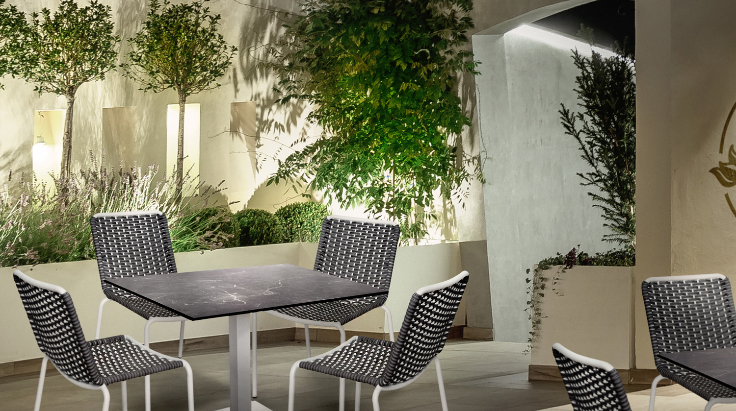 Clean Dining | Captiva Chairs with Pietro Tables in an dramatic outdoor dining courtyard